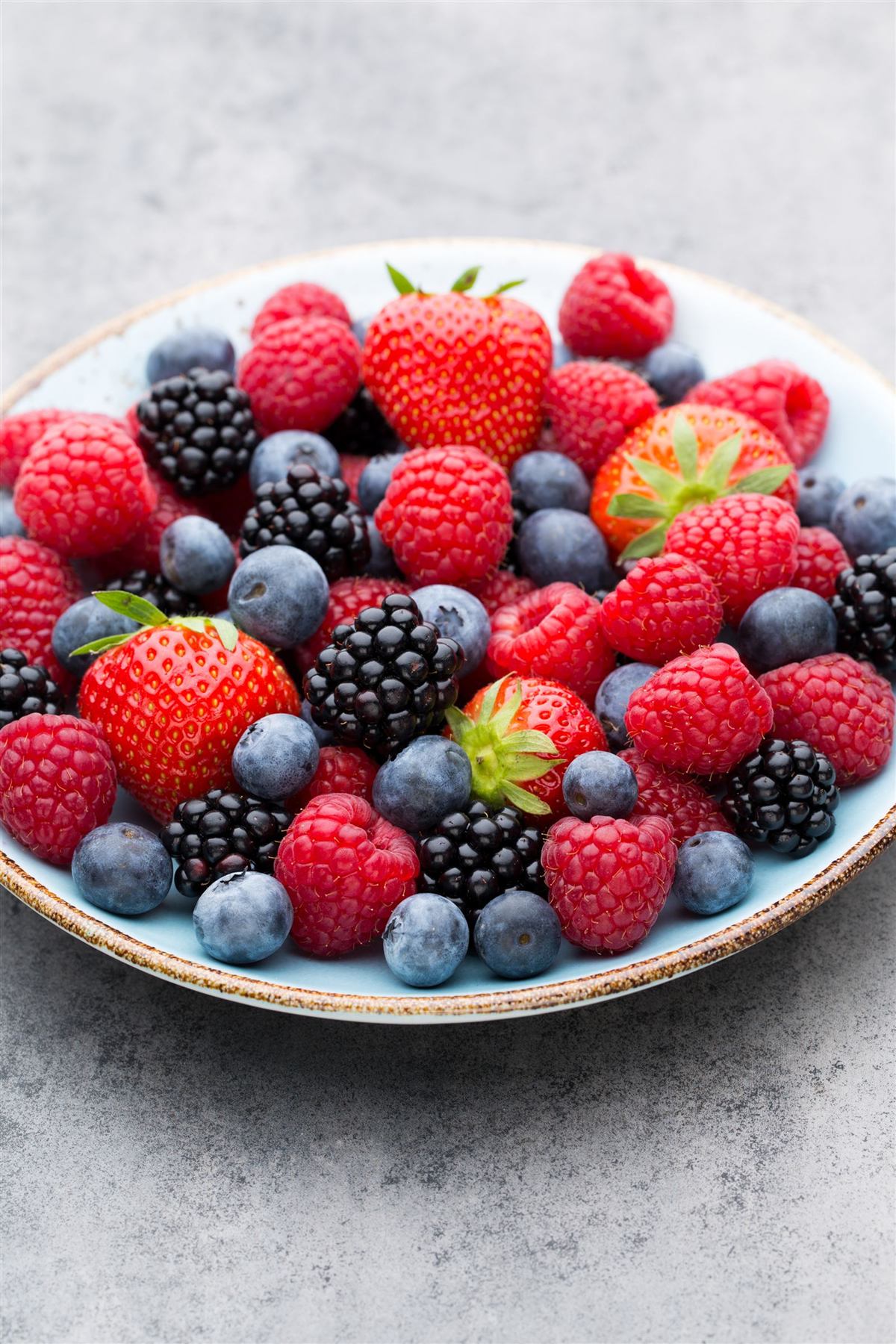 A bowl of strawberries, blueberries and raspberries