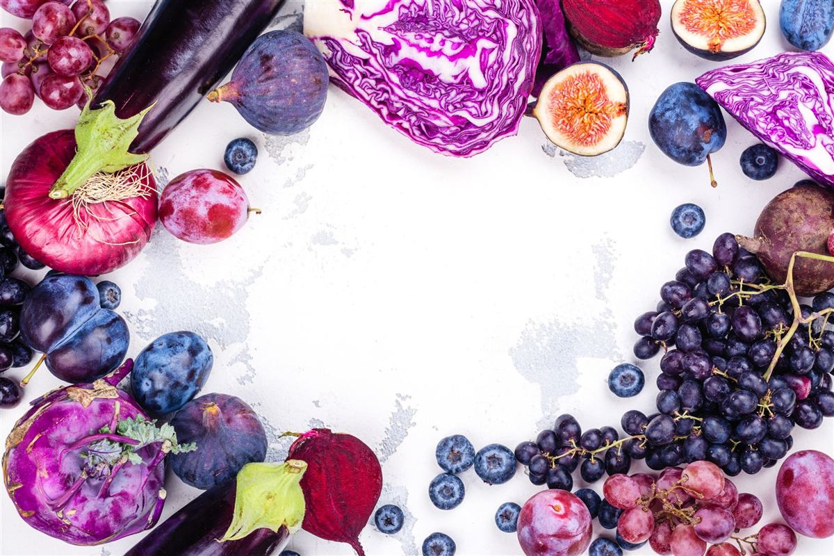 Purple vegetables and berries arranged in a frame
