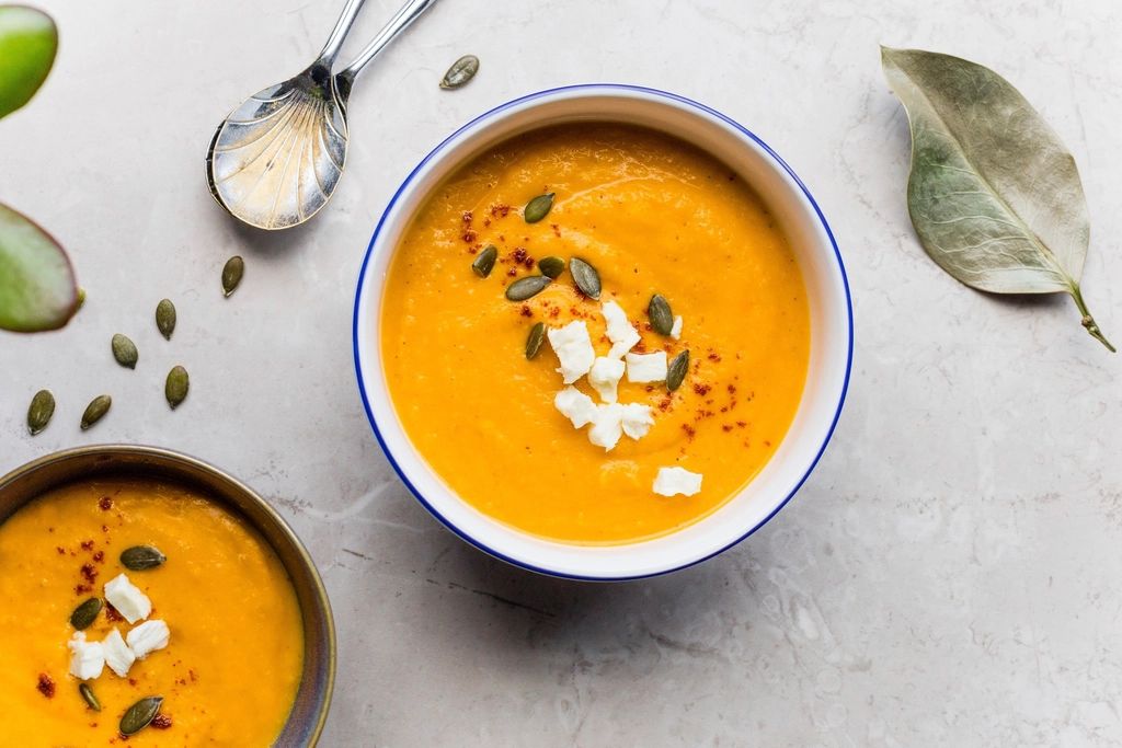 Two bowls of pumpkin soup