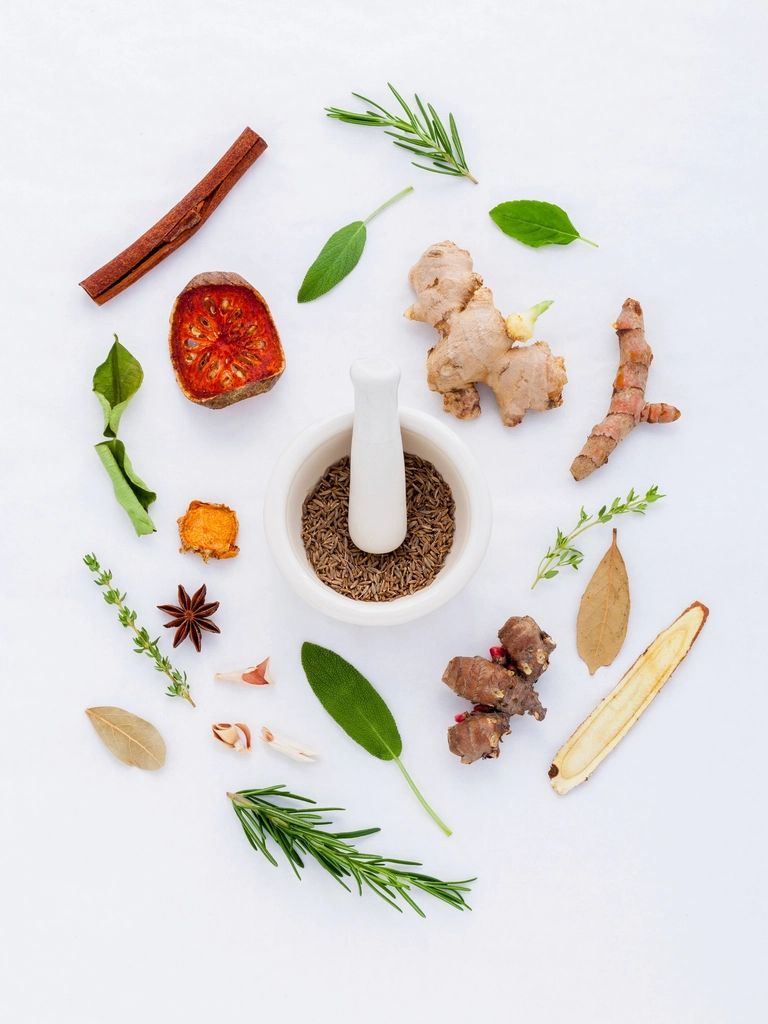 Herbs and spices arranged around a mortar and pestle